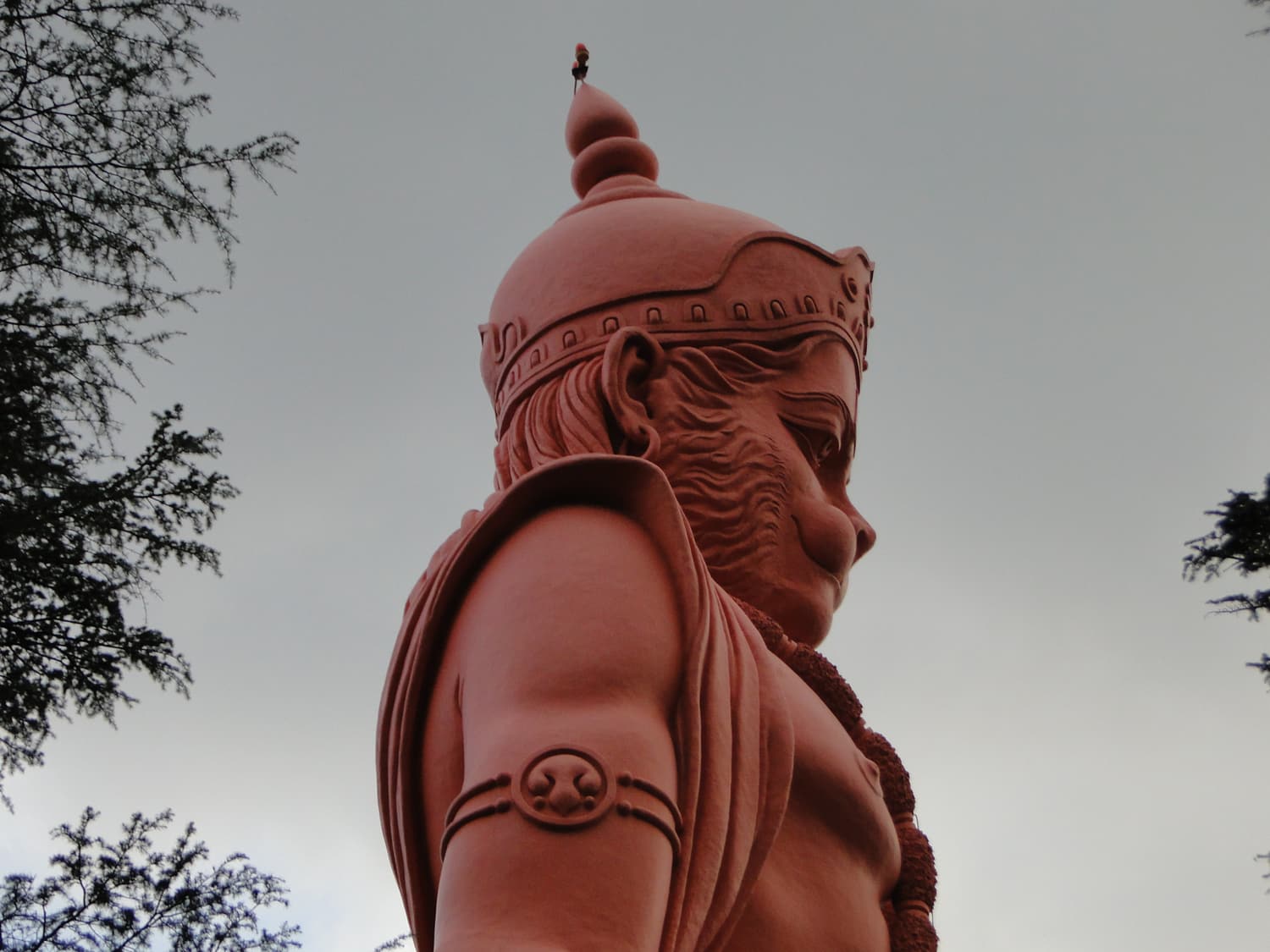 The giant Hanuman statue at Jakhoo Temple rising above the treetops
