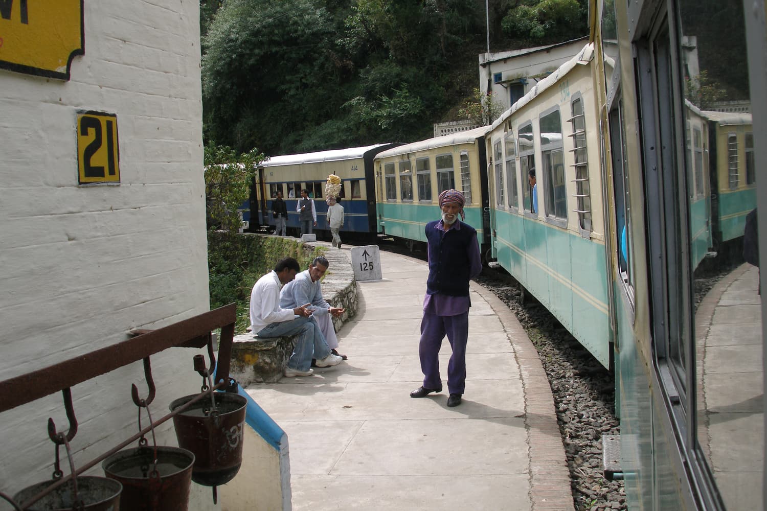 A blue-and-cream carriage of the Kalka–Shimla toy train at a hill station platform