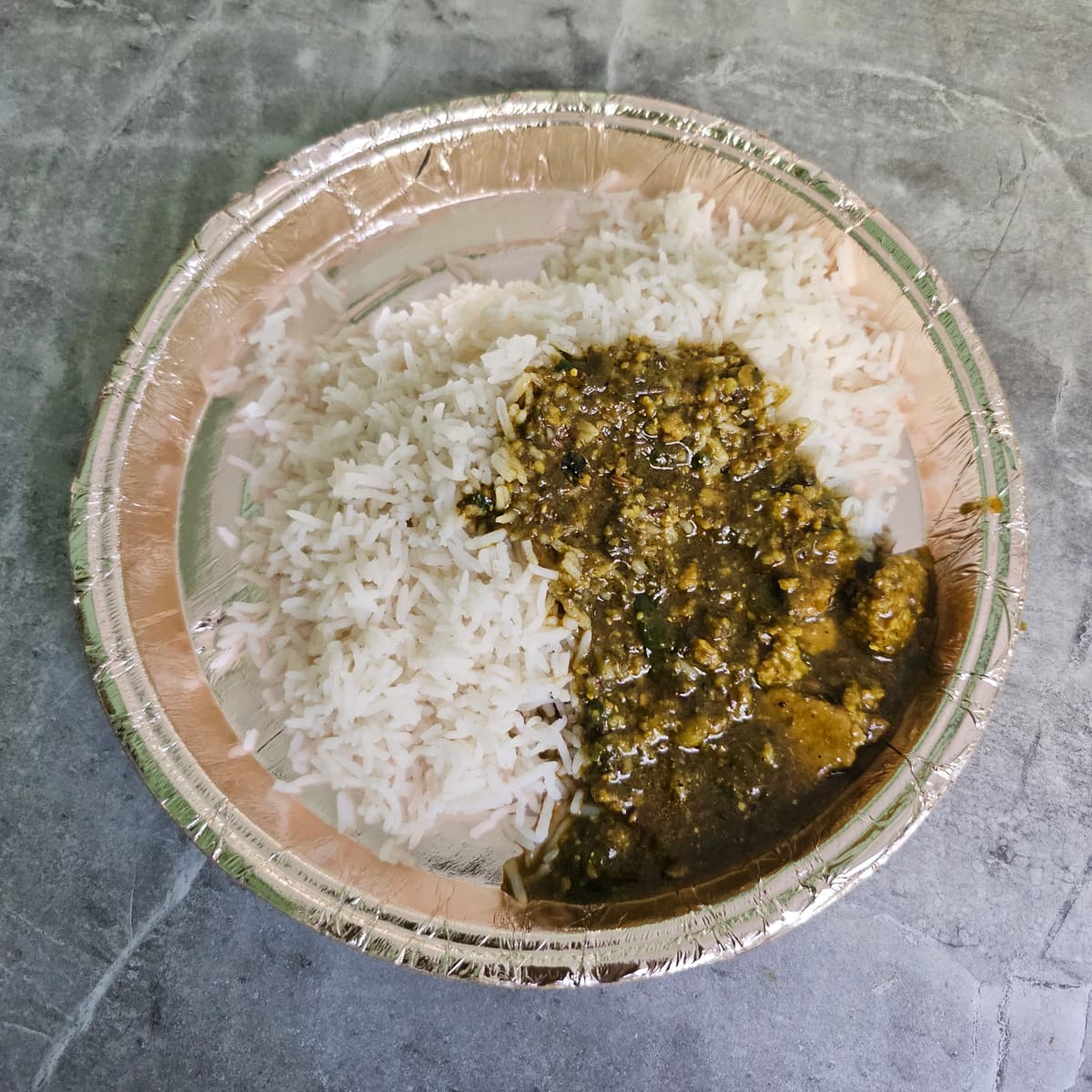 A Himachali dham meal of rice and curry served on a leaf plate