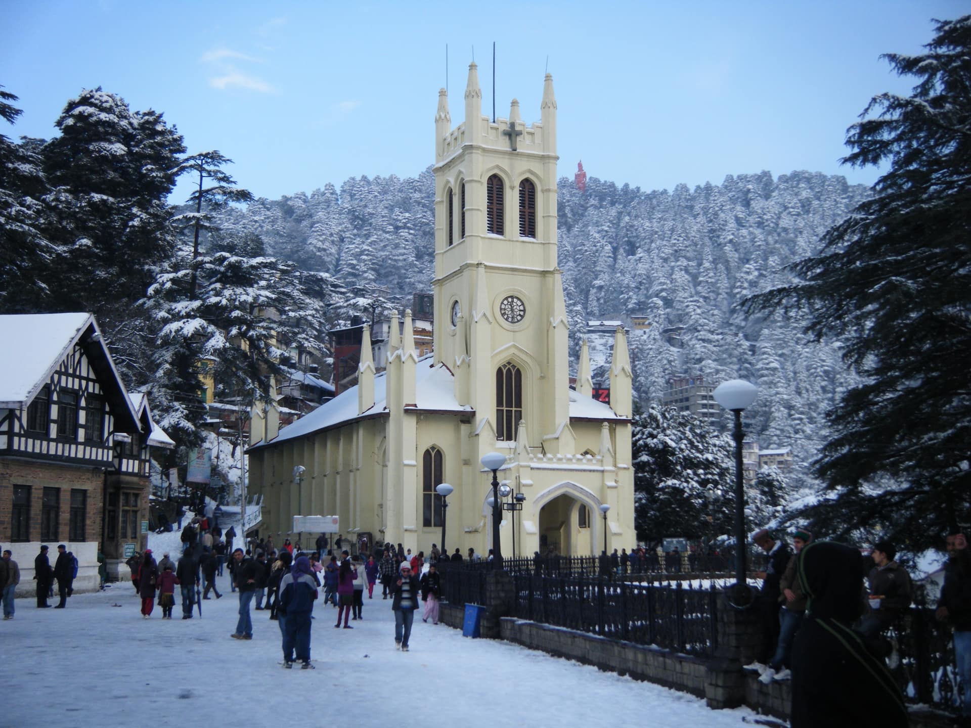 Christ Church on the snow-covered Ridge in Shimla with deodar-clad hills behind